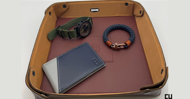 Forrest and Harold wallet for travel placed in a travel bag together with other travel essentials. Photo by Forrest and Harold- the best place to buy sophisticated travel wallets for men...
