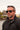 A person wearing handmade wooden sunglasses with a wayfarer style.